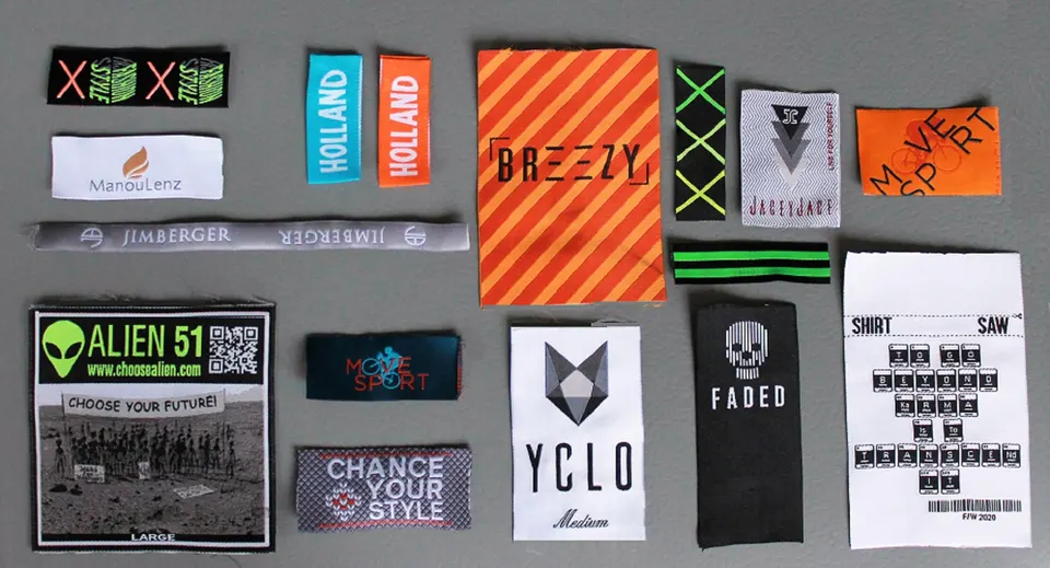 Folded woven brand labels in neon green, orange, black and white